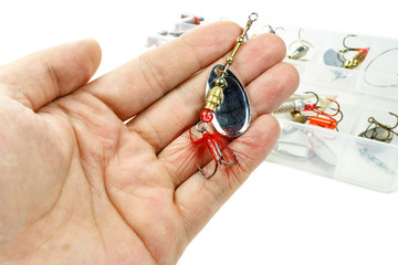 Metal spinner for catching predatory fish in the palm of the fisherman