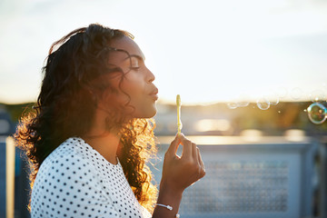 Pretty woman blowing bubbles