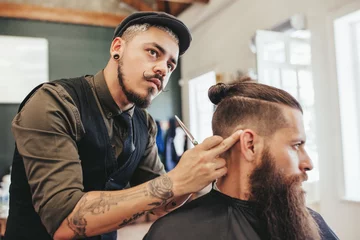 Foto auf Acrylglas Friseur Barber checking symmetry of haircut