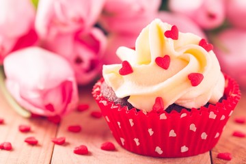 homemade valentine cupcakes with red sugar hearts and pink tulips