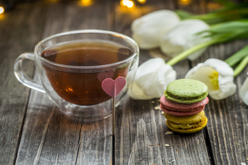 white tulips and a transparent Cup of tea