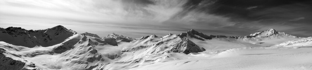 Black and white panorama of Caucasus Mountains in snow winter ev