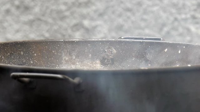 Dine preparing in a large wok
