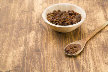 Raisins on a wooden spoon