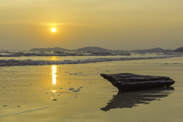 Beautiful view of the sun set at the beach with the timber.