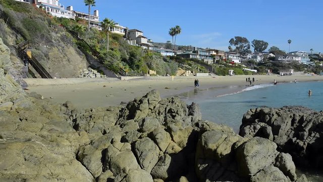A beautiful pan of Shaws Cove in Laguna Beach, California shows the high style of living along scenic, horseshoe oceanfront