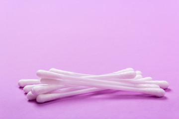 closeup clean ear sticks on violet background slide