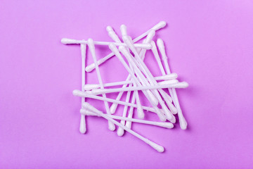 closeup clean ear sticks on violet background slide