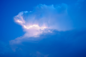 Lightnings in storm clouds. Peals of a thunder and the sparkling lightnings in clouds