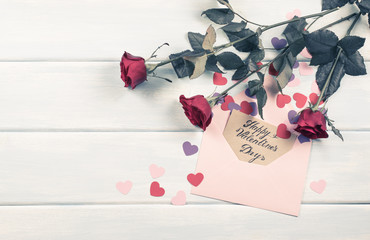 Roses with Valentine hearts and greeting card with hand drawn inscription