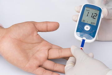 Doctor checking blood sugar level. doctor patient diabetes lance