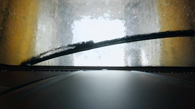 View from the inside of car being washed at automatic wash station