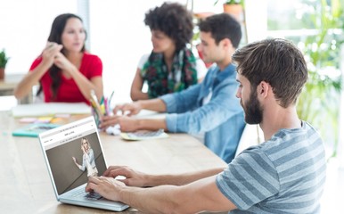 Fototapeta premium Composite image of casual businessman typing on his laptop 