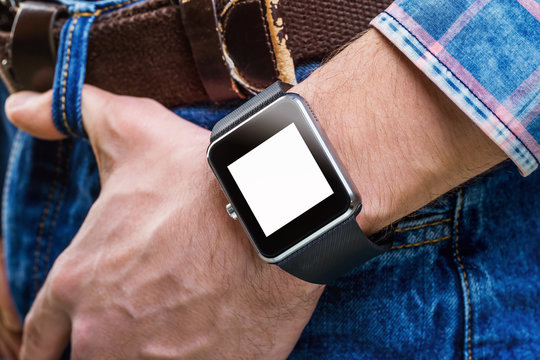 Closeup mockup of smart watches on male hand at blue jeans 