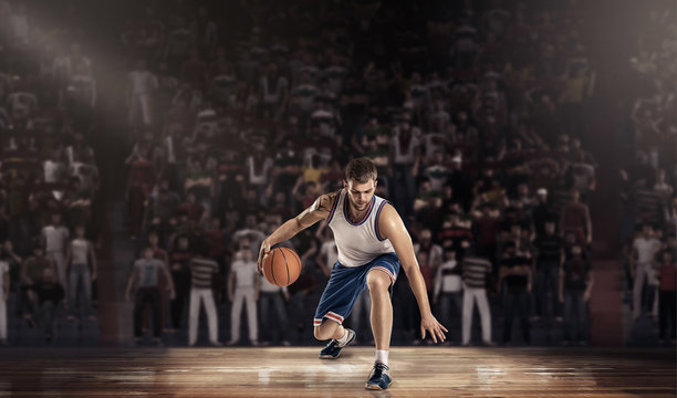 basketball player on court with ball in light rays