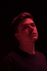 one man looking above up, red color light