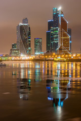 Panoramic night view on skyscrapers of the Moscow City International Business Center near river Moscow, Moscow, Russia.