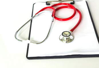 red stethoscope and medical report on clean table