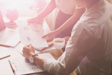 Businessman supervising his assistant's work on the laptop compu