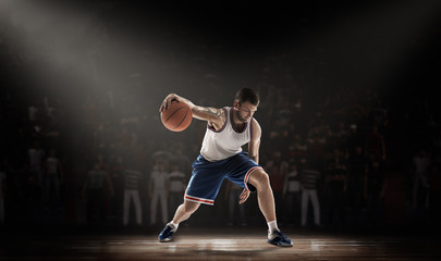 basketball player on stadium in durkness with light ray