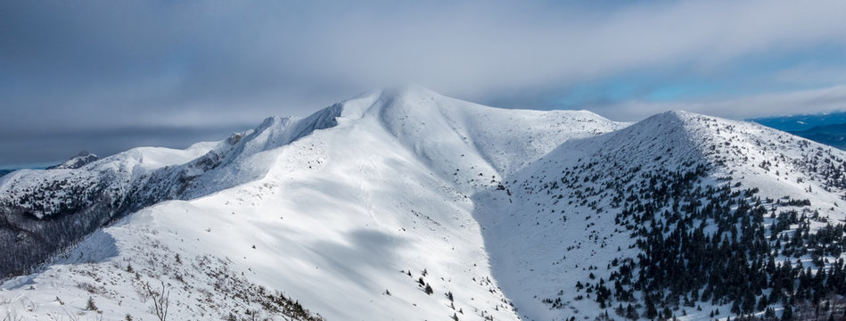 Panorama of winter mountain ridge with Little Krivan hill