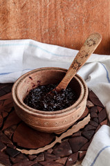 berries in jam on a wooden plate