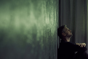 Man in gloomy room