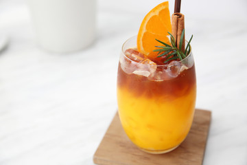 Orange juice with ice in white coffeeshop