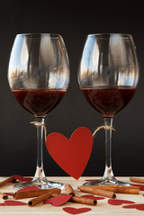 Two glasses of red wine tied with red heart