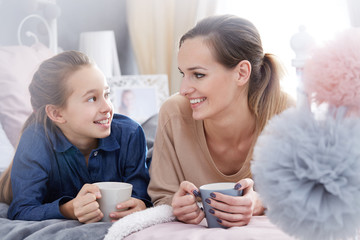Mother and daughter drinking tea
