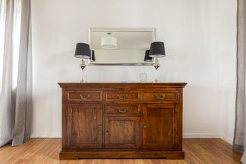 Closer shot of stylish wooden commode