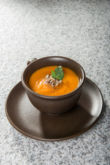 Brown cup with squash soup