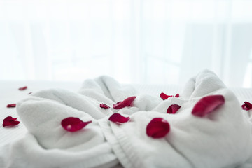 Decoration from towels surround by red rose petals