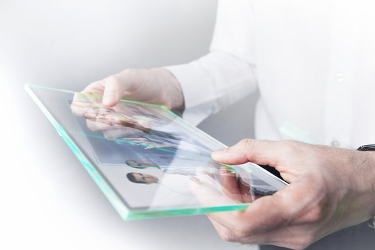 Man with futuristic glass tablet