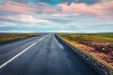 Empty asphalt road with colorful cloudy sky.