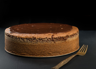Whole chocolate cake on the table