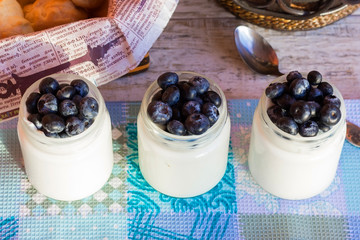 Three jars of yoghurt with berries