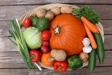 Fall harvest - big basket with pumpkin and vegetables