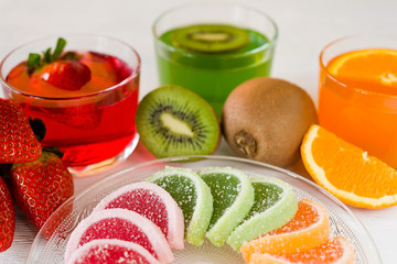 Colorful fruit jelly candies arranged in circle on wooden table.