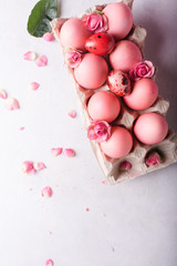 Pink Easter eggs on light background. Copyspace. Still life photo of lots of pink easter eggs.Background with easter eggs. Pink eggs and roses. Easter photo concept
