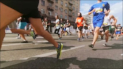 Slow motion blurred video of crowd running on marathon