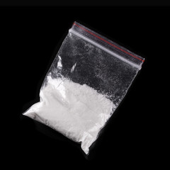Cocaine in plastic packet on black background - obrazy, fototapety, plakaty