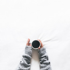 Top view of woman holding cup of coffee