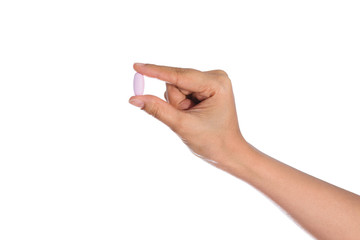 Woman's hand holding black pill