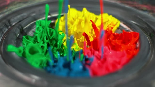 Rainbow paint bounces, splashing on a thumping speaker playing loud music