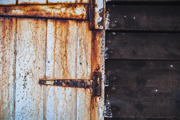 Old wooden door and rusty lock