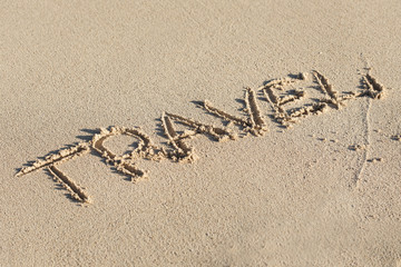 Inscription Travel on sandy beach