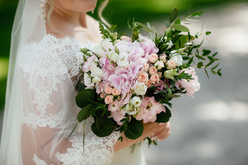 the bride holding a bouquet. wedding flowers. soft focus.