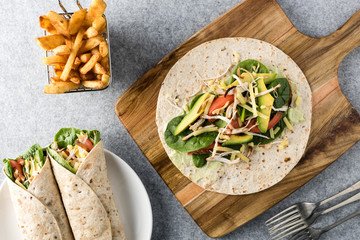 shredded barbecued chicken wraps with carrot, cheese, avocado an
