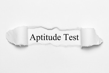 Aptitude Test on white torn paper